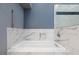 Modern bathtub with marble-style tile, a shower head, a handheld sprayer, and a built-in soap dish at 3109 Bangor Ct, Las Vegas, NV 89134