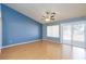 Spacious bedroom features light wood flooring, a ceiling fan, a window, and a sliding glass door to the backyard at 3109 Bangor Ct, Las Vegas, NV 89134