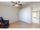 A well-lit bedroom featuring a ceiling fan, light wood flooring, and a closet with sliding doors at 3109 Bangor Ct, Las Vegas, NV 89134