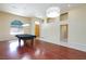 Well-lit game room with a pool table, hardwood floors, and a view of the front door at 3109 Bangor Ct, Las Vegas, NV 89134