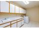 Functional laundry room with ample storage cabinets and sink at 3109 Bangor Ct, Las Vegas, NV 89134