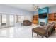 Living room features white tile flooring, French doors, fireplace, and custom built-in shelving at 3109 Bangor Ct, Las Vegas, NV 89134