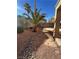 Backyard featuring decorative rock landscaping with a view of surrounding trees at 3177 Rabbit Creek Dr, Las Vegas, NV 89120