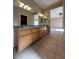 Bathroom featuring double sinks with granite countertops and tiled floors at 3177 Rabbit Creek Dr, Las Vegas, NV 89120