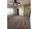 Bedroom with carpet flooring, ceiling fan, and a large window at 3177 Rabbit Creek Dr, Las Vegas, NV 89120