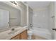 Well-lit bathroom features a tub, toilet, sink with vanity, mirror, and white tiled shower at 3412 Winterhaven St # 101, Las Vegas, NV 89108