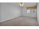 Spacious carpeted bedroom with a ceiling fan and a window with blinds at 3412 Winterhaven St # 101, Las Vegas, NV 89108