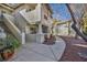 Exterior view of condo building with private balconies, landscaped walkway, and tree at 3412 Winterhaven St # 101, Las Vegas, NV 89108