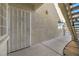 Private entrance to a condo unit with security door and a peaceful, well-lit walkway at 3412 Winterhaven St # 101, Las Vegas, NV 89108