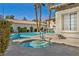 Inviting hot tub adjacent to the community pool, surrounded by lush landscaping and palm trees at 3412 Winterhaven St # 101, Las Vegas, NV 89108