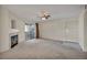 Open living room featuring a fireplace, ceiling fan, carpeted floors, and a sliding glass door leading to the outside at 3412 Winterhaven St # 101, Las Vegas, NV 89108