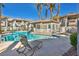 Relaxing community pool area with lounge chair, featuring a covered cabana for shade and leisure at 3412 Winterhaven St # 101, Las Vegas, NV 89108