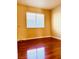 A bright bedroom featuring hardwood floors, a neutral color scheme, and natural light at 3438 Ceremony Dr, Las Vegas, NV 89117