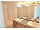 Bathroom featuring double sinks, a large mirror with vanity lighting, and a shower/tub combo at 3850 Soda Springs Dr, Las Vegas, NV 89115