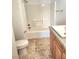 Bathroom featuring a white toilet, vanity, and a shower/tub with a vinyl surround at 3850 Soda Springs Dr, Las Vegas, NV 89115