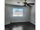 An empty bedroom featuring neutral-colored walls, hardwood floors, and a ceiling fan at 3850 Soda Springs Dr, Las Vegas, NV 89115