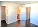 View into an empty bedroom displaying hardwood floors, with access to an attached bath and closet at 3850 Soda Springs Dr, Las Vegas, NV 89115