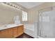 Bathroom features a double sink, large mirror, bathtub and glass door shower at 3941 Yellow Mandarin Ave, North Las Vegas, NV 89081