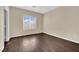 This bedroom features a window, beautiful dark floors, and base molding at 3941 Yellow Mandarin Ave, North Las Vegas, NV 89081