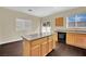 Bright kitchen with an island, hardwood floors, and a sliding glass door at 3941 Yellow Mandarin Ave, North Las Vegas, NV 89081