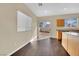 Eat-in kitchen with wood cabinets, hardwood floors, and a sliding glass door at 3941 Yellow Mandarin Ave, North Las Vegas, NV 89081