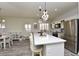 Spacious kitchen with a large quartz island, stainless steel appliances, and hanging pendant lights at 4300 S Gressa St, Pahrump, NV 89061