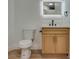 Bathroom with oak vanity, illuminated mirror and modern toilet at 4412 Denia Cir, Las Vegas, NV 89108