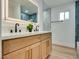 Modern bathroom with a double vanity, wood cabinets, and a large mirror at 4412 Denia Cir, Las Vegas, NV 89108