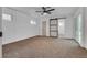 Spacious carpeted bedroom with white walls, ceiling fan and sliding door with backyard access at 4412 Denia Cir, Las Vegas, NV 89108