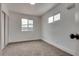 Bright bedroom featuring neutral carpet, two windows, and closet with sliding doors at 4412 Denia Cir, Las Vegas, NV 89108