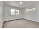 Bright bedroom featuring neutral carpet, white walls, and natural light from two windows at 4412 Denia Cir, Las Vegas, NV 89108