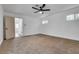 Bright bedroom featuring neutral carpet and white walls with view of the entrance hall at 4412 Denia Cir, Las Vegas, NV 89108