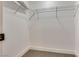 Walk-in closet with neutral carpet, white walls, metal shelving, and white trim at 4412 Denia Cir, Las Vegas, NV 89108