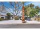 A single story house with a well-landscaped front yard with mature trees at 4412 Denia Cir, Las Vegas, NV 89108