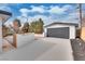 Detached two car garage with a large concrete driveway and landscaped yard at 4412 Denia Cir, Las Vegas, NV 89108