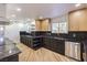 Bright kitchen featuring stainless steel appliances, contrasting cabinetry and stone countertops at 4412 Denia Cir, Las Vegas, NV 89108