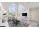 Bright living room featuring tall windows and a minimalist floating staircase with cable railings at 4515 Dean Martin Dr # 201, Las Vegas, NV 89103