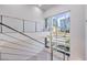 Modern staircase with metal railing and large windows offer abundant natural light and city views at 4515 Dean Martin Dr # 201, Las Vegas, NV 89103