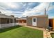 Backyard with a shed, turf, brick trim, and patio extending off the back of the home at 4606 Cory Pl, Las Vegas, NV 89107