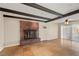 Spacious living room featuring tile floors, brick fireplace, and sliding glass doors at 4606 Cory Pl, Las Vegas, NV 89107