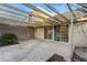 View of the covered back patio and sliding glass door at 4648 Comnor Hill Ln, Las Vegas, NV 89121