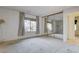 Large bedroom with mirrored closet doors, a large window, and neutral colored carpet at 4648 Comnor Hill Ln, Las Vegas, NV 89121