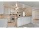 Kitchen boasts white appliances, ample counter space, and casual breakfast bar at 4648 Comnor Hill Ln, Las Vegas, NV 89121