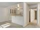 Cozy kitchen with white cabinetry, serving bar, and standard appliances at 4648 Comnor Hill Ln, Las Vegas, NV 89121