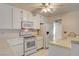 Kitchen featuring tile countertops, white appliances, and ample cabinet space at 4648 Comnor Hill Ln, Las Vegas, NV 89121