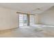 Interior view of the living room featuring sliding glass doors to a covered patio and ready for personalized updates at 4648 Comnor Hill Ln, Las Vegas, NV 89121