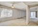 Living room featuring a bright window, ceiling fan, and neutral color palette at 4648 Comnor Hill Ln, Las Vegas, NV 89121