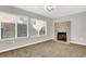 Spacious living room with a decorative fireplace and large windows at 4809 Mountain Valley Rd, Las Vegas, NV 89121