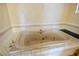 A close-up of a large pink bathtub surrounded by white tile at 4911 W Pebble Rd, Las Vegas, NV 89139