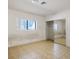 Bedroom with tile flooring, large window, and closet with mirrored doors at 4911 W Pebble Rd, Las Vegas, NV 89139